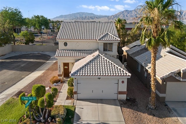 view of front of house featuring a garage and a mountain view