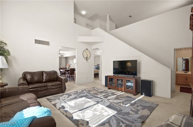 living room featuring light carpet, high vaulted ceiling, and ceiling fan