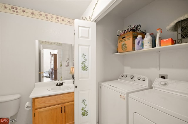 clothes washing area featuring sink and washing machine and dryer