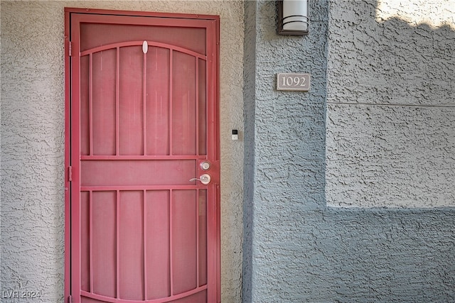 view of exterior entry featuring stucco siding