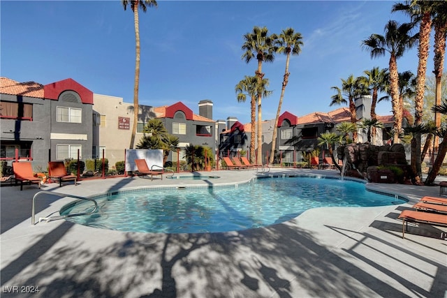 pool featuring a patio area, a residential view, and fence