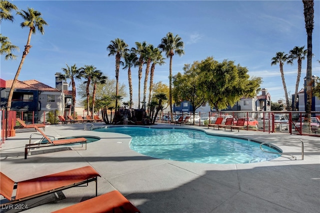 community pool featuring a patio area and fence