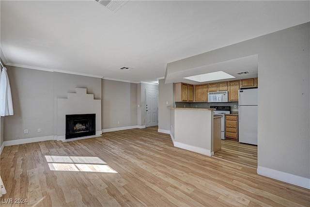 kitchen featuring white appliances, brown cabinetry, light wood-style flooring, and visible vents