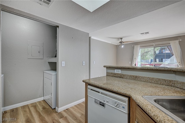 kitchen with baseboards, visible vents, dishwasher, light wood-style flooring, and washer / clothes dryer