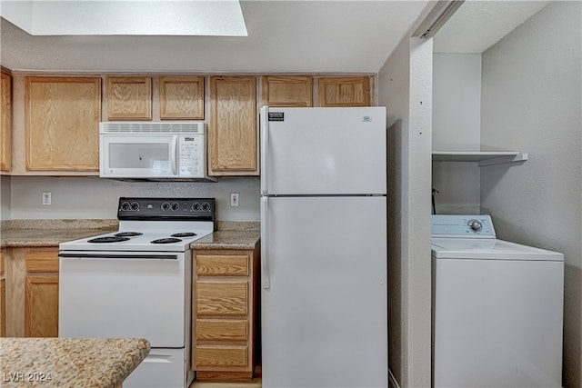 kitchen featuring washer / clothes dryer and white appliances