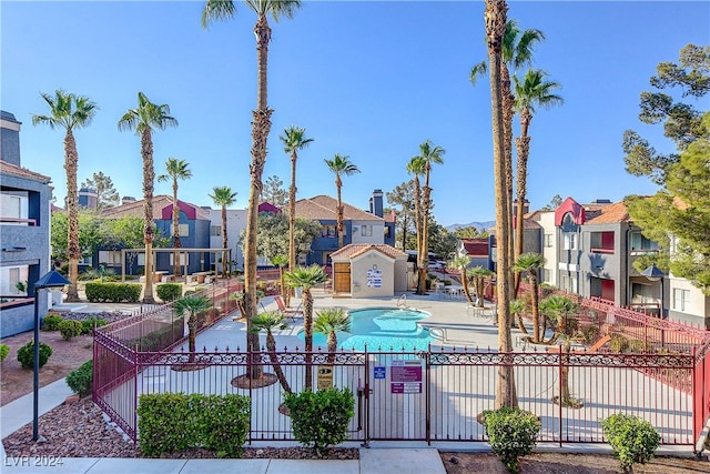 view of swimming pool with fence and a residential view