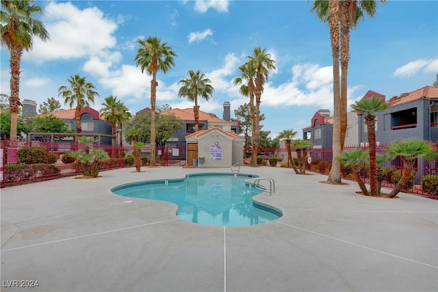 pool featuring a patio area and fence