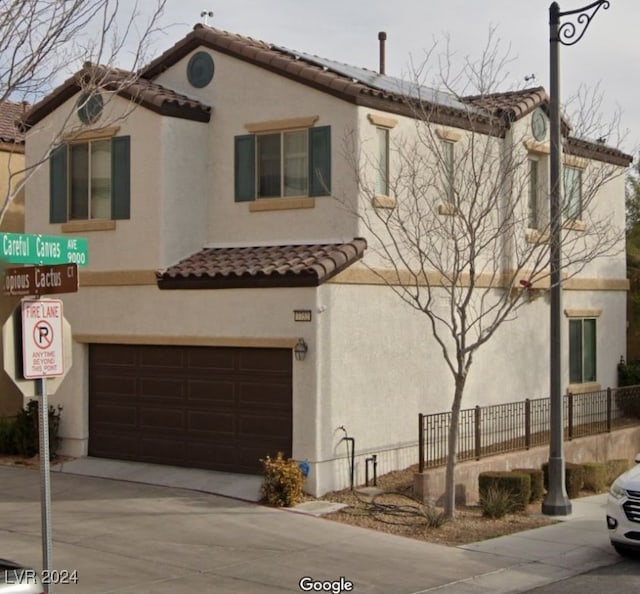 mediterranean / spanish house featuring a garage