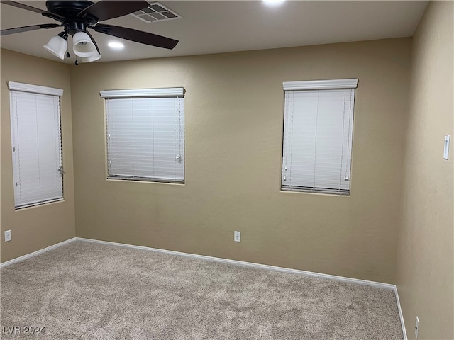 unfurnished room with ceiling fan and light carpet