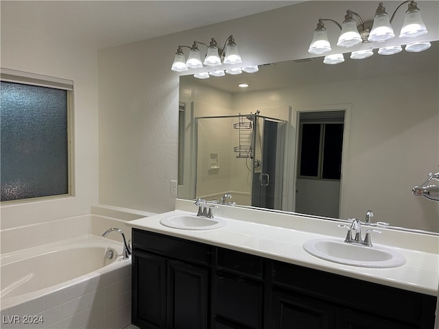 bathroom featuring shower with separate bathtub and vanity