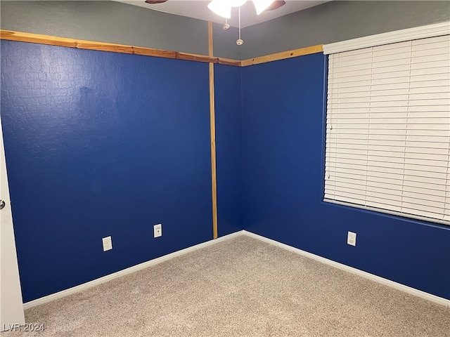 spare room featuring carpet floors and ceiling fan