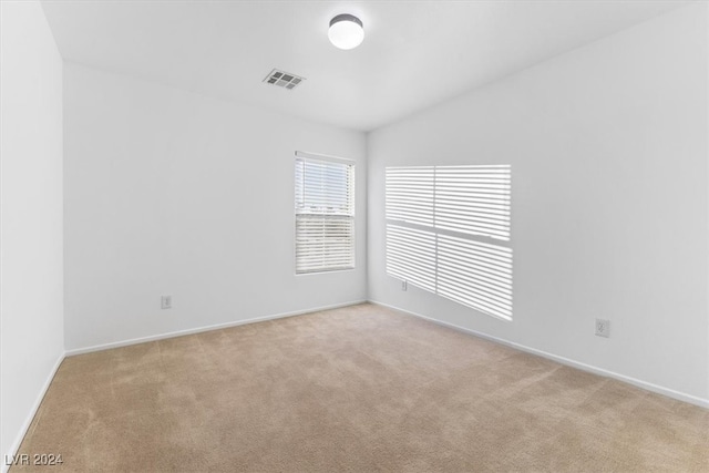 empty room featuring light carpet