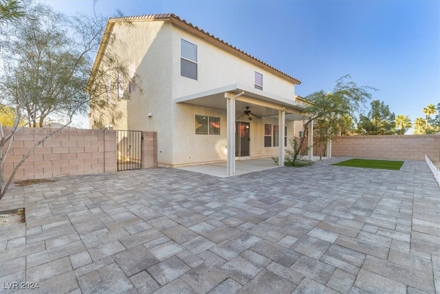 back of property featuring a patio and ceiling fan