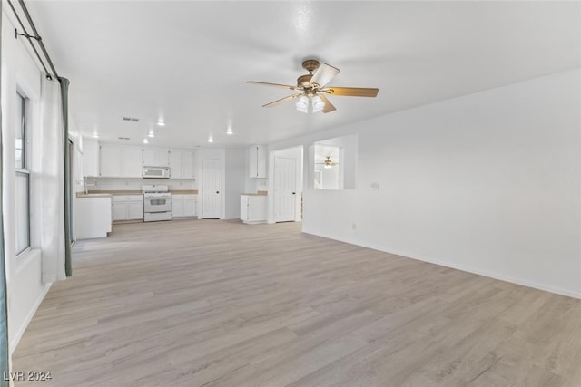 unfurnished living room featuring ceiling fan and light hardwood / wood-style flooring