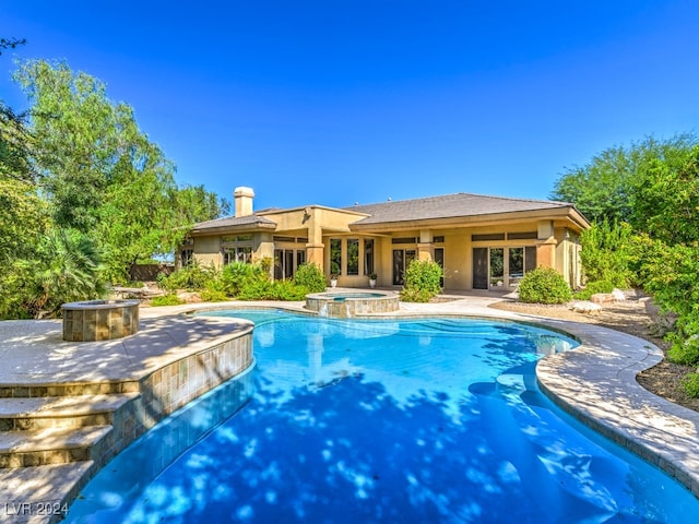 view of pool featuring a patio and an in ground hot tub