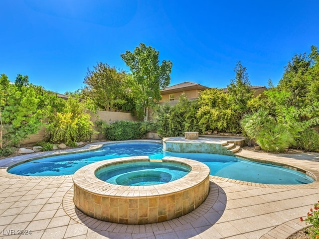 view of swimming pool featuring an in ground hot tub