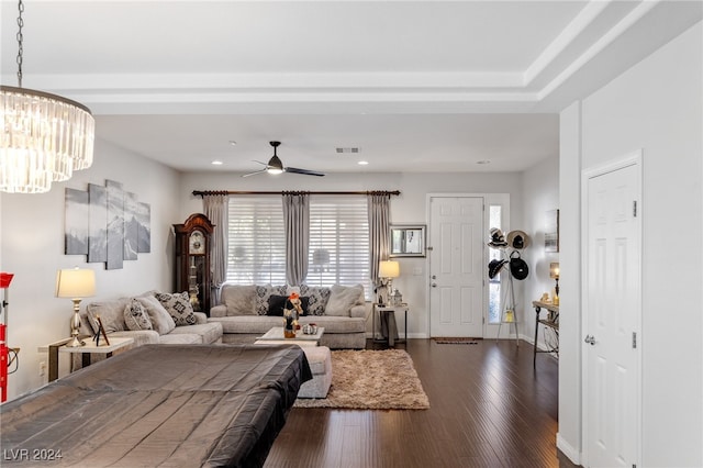 living room featuring dark hardwood / wood-style floors and ceiling fan with notable chandelier