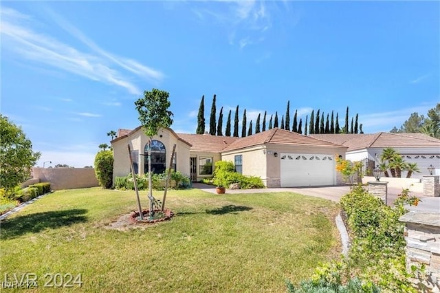 view of front of house with a garage and a front lawn