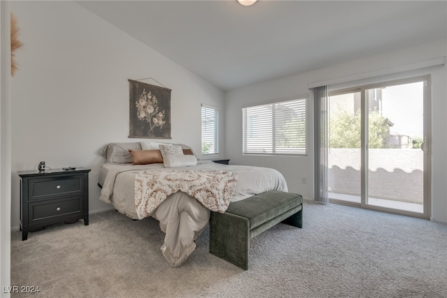 carpeted bedroom featuring lofted ceiling, access to outside, and multiple windows