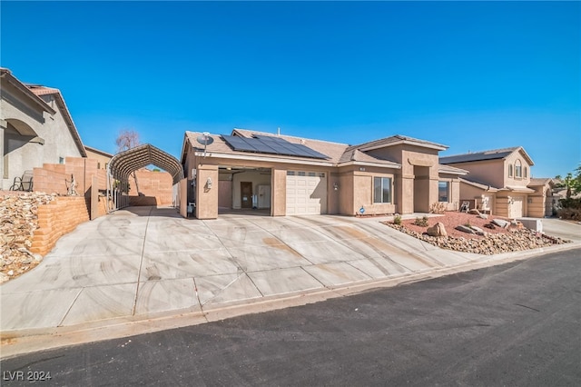 view of front of home with a garage and solar panels