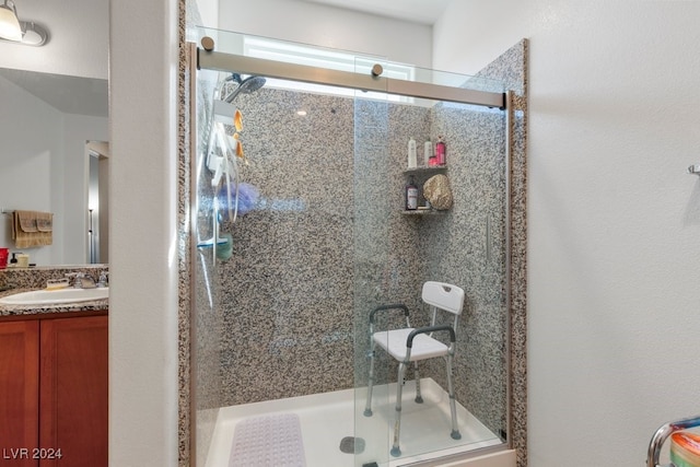 bathroom with vanity and a shower with shower door