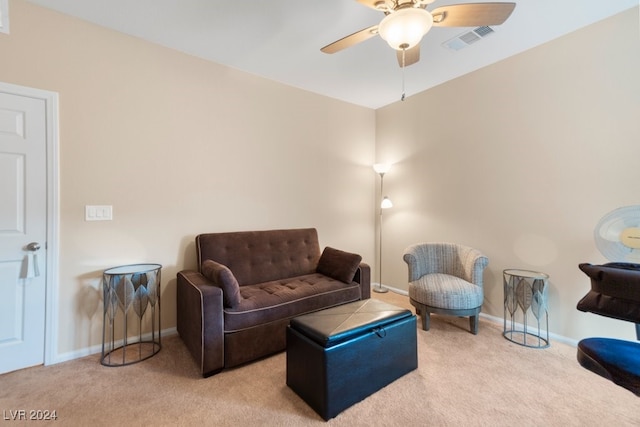 carpeted living room with ceiling fan