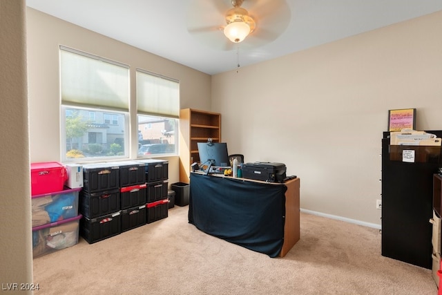 carpeted office space featuring ceiling fan