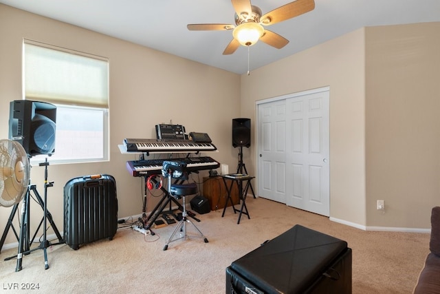 exercise area with ceiling fan and light colored carpet