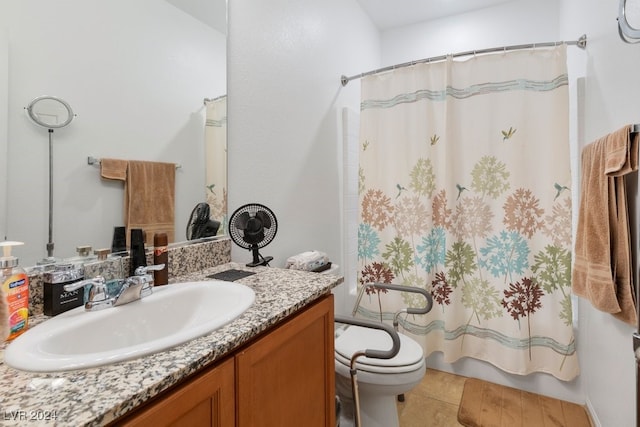 full bathroom with tile patterned floors, vanity, shower / bath combo with shower curtain, and toilet