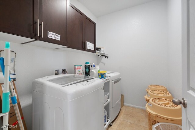 laundry room with light tile patterned floors, cabinets, and independent washer and dryer