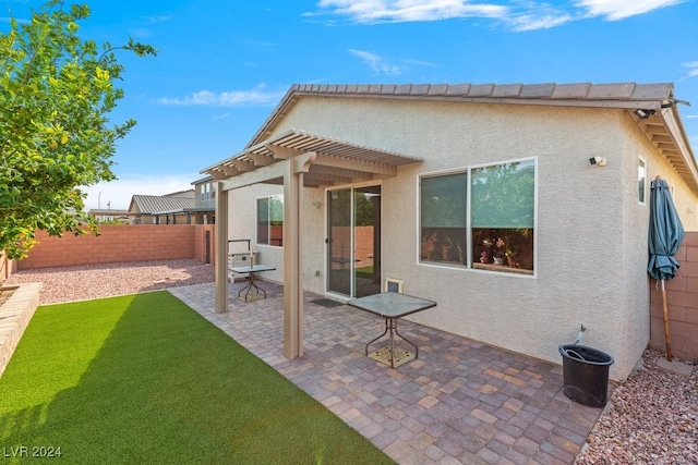 rear view of house with a yard and a patio