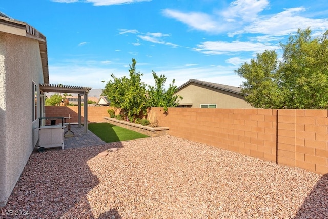 view of yard with a pergola and a patio area