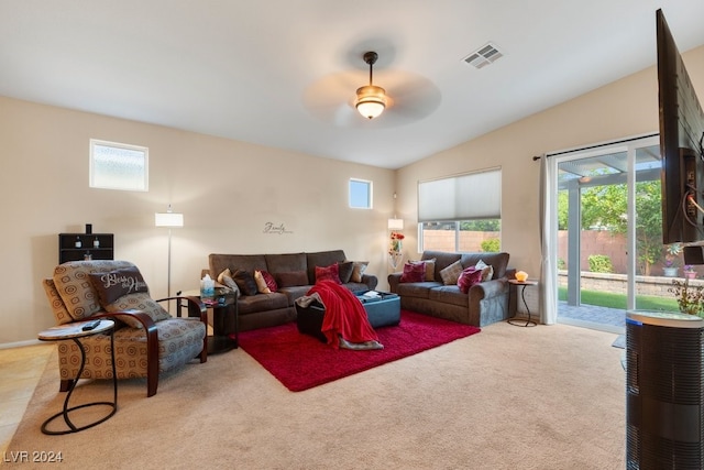 carpeted living room with plenty of natural light, vaulted ceiling, and ceiling fan