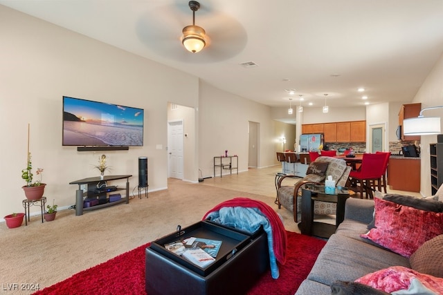 living room with ceiling fan and light colored carpet