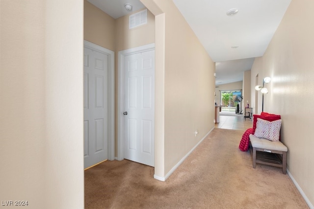 hallway with light colored carpet