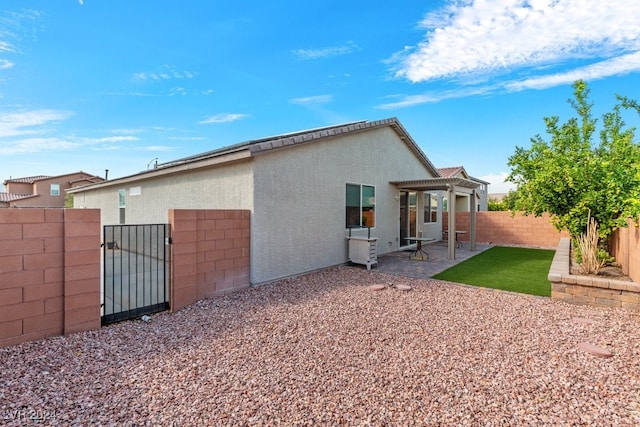 back of property with a patio