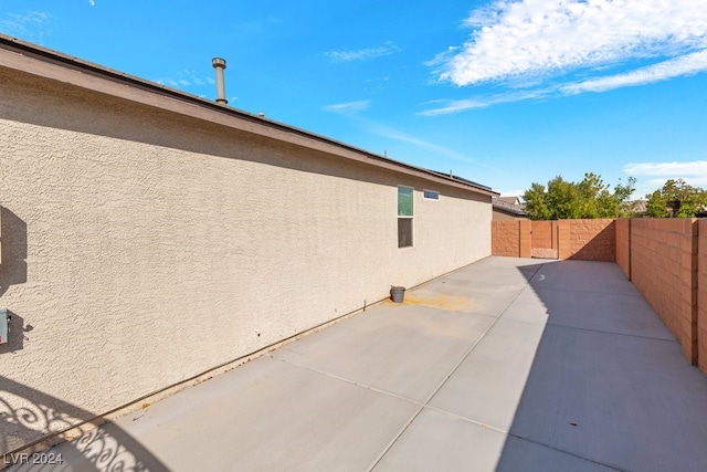 view of side of property with a patio area