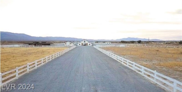 view of street with a mountain view and a rural view