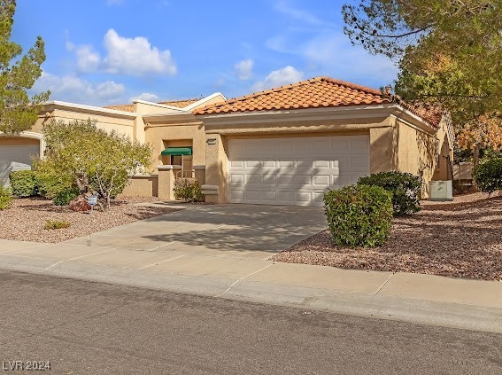 mediterranean / spanish house with a garage