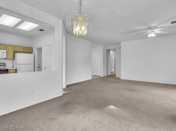 interior space with ceiling fan with notable chandelier and carpet floors