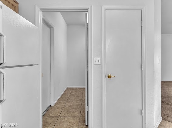 hall with light tile patterned floors