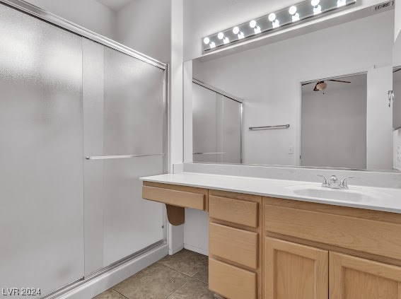 bathroom with tile patterned flooring, vanity, and a shower with shower door