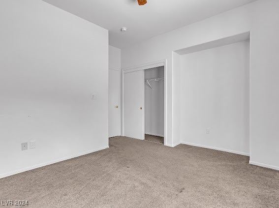 unfurnished bedroom with a closet and carpet