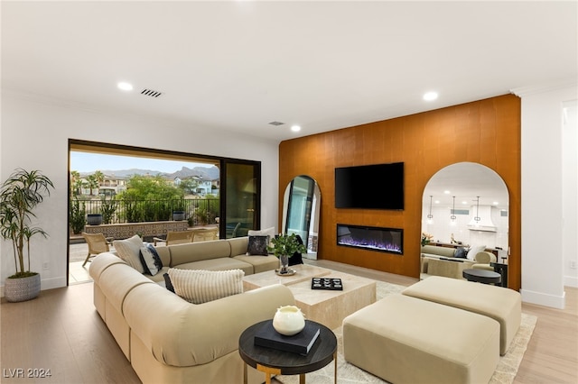 living room with wood walls and light hardwood / wood-style flooring