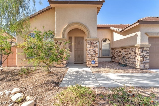 view of exterior entry with a garage