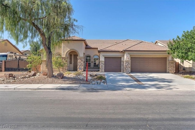 3689 Callahan Ave, Las Vegas, NV 89120 - view of front of house featuring stucco siding, a garage, stone siding, concrete driveway, and fence
