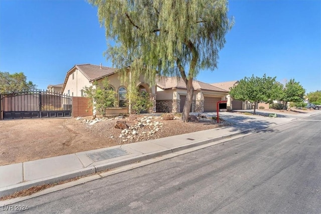 3689 Callahan Ave, Las Vegas, NV 89120 - obstructed view of property with an attached garage, a gate, stucco siding, driveway, and fence