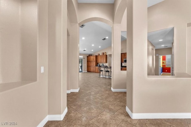 3689 Callahan Ave, Las Vegas, NV 89120 - hallway featuring baseboards, arched walkways, tile patterned flooring, lofted ceiling, and recessed lighting
