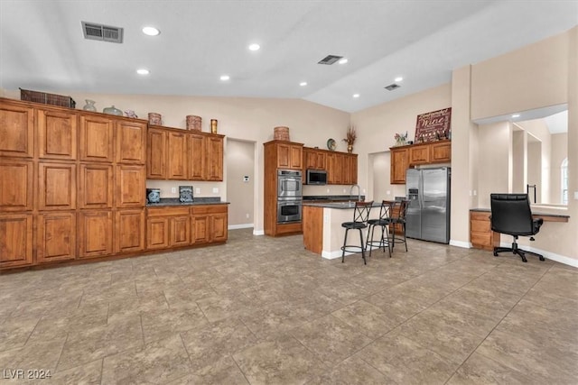 3689 Callahan Ave, Las Vegas, NV 89120 - kitchen featuring stainless steel appliances, brown cabinets, a breakfast bar area, dark countertops, and lofted ceiling