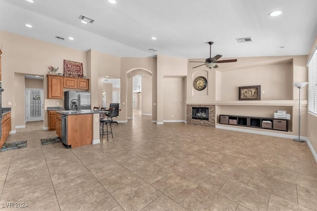 3689 Callahan Ave, Las Vegas, NV 89120 - living room with ceiling fan, arched walkways, a glass covered fireplace, baseboards, and recessed lighting